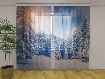 Christmas curtains - a magical view of snow-covered trees at sunset Tapetenshop.lv